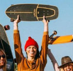 Woman holding her skateboard.